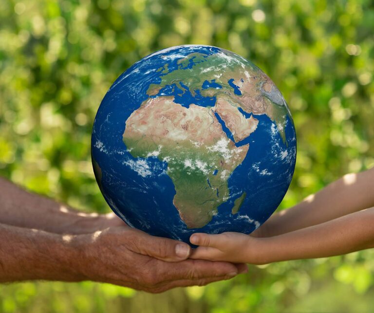 senior man and child holding earth planet